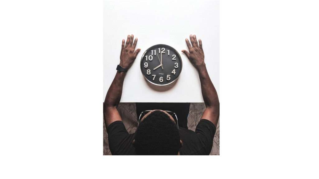 Time management. Round silver colored wall clock
