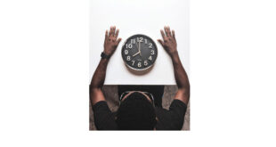 Time management. Round silver colored wall clock